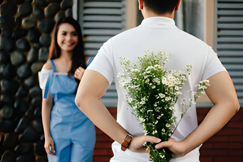 a person holds flowers behind the back